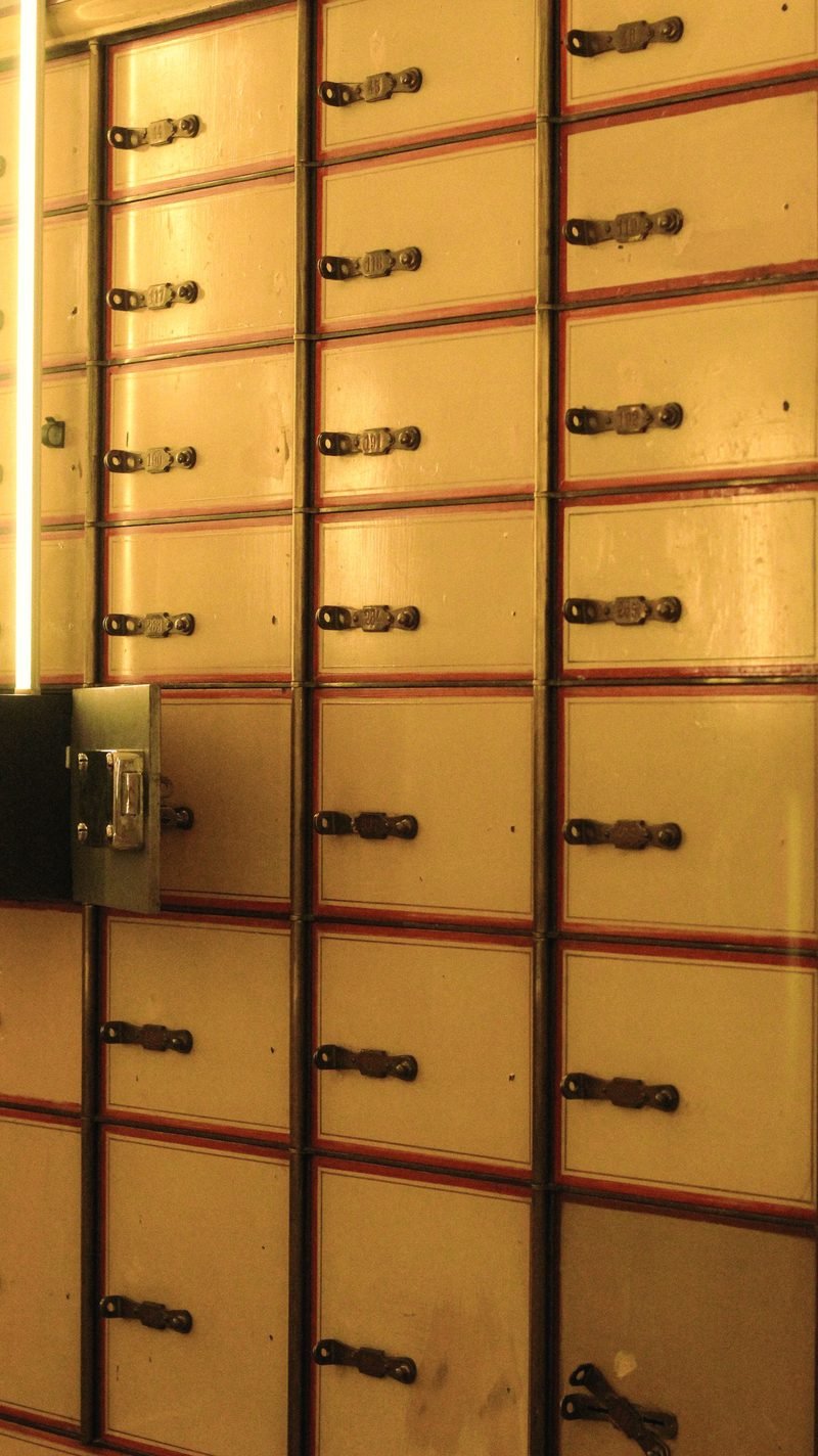 A wall of gold-toned lockboxes, each with its own keyhole